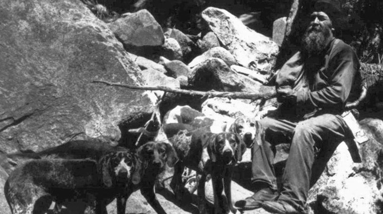 black and white photo of ben lilly and his hunting dogs