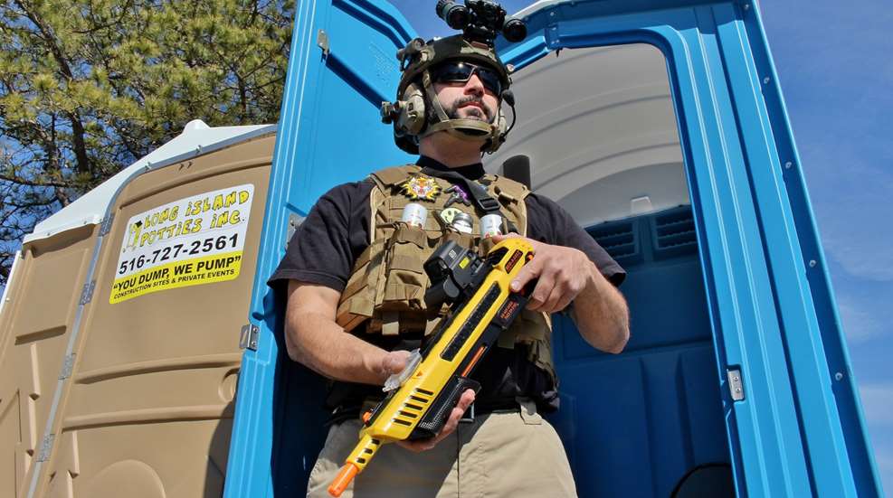 The author in full battle array, wielding Bug-A-Salt in defense of a porta-potty.