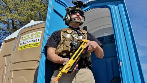 Frank Melloni in full battle rattle guarding a Porta-Potti