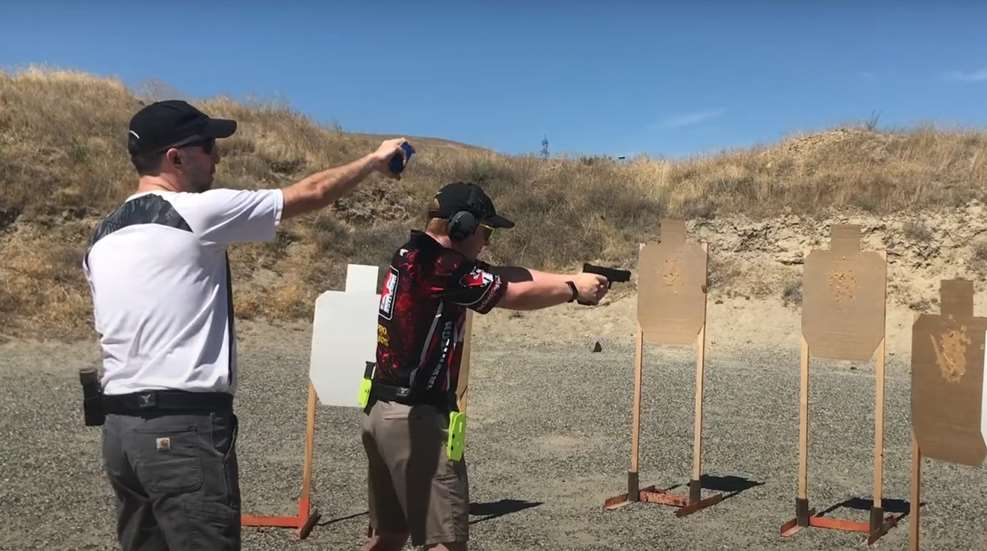 junior shooter wearing safety gear shooting in pistol competition