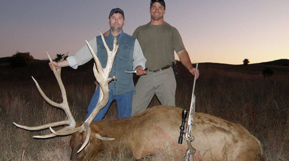 hunter and guide with downed elk
