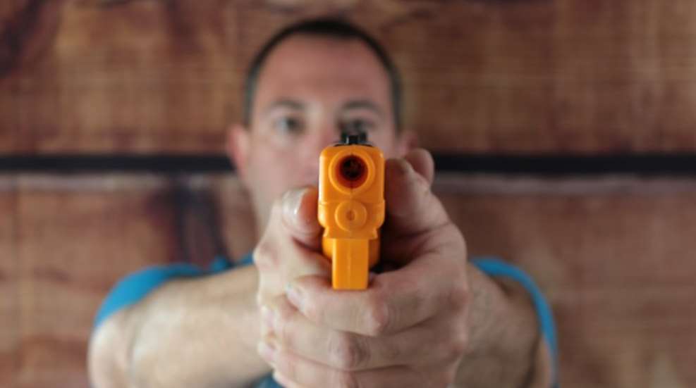 Author demonstrates 'septum method' using non-functioning, no moving parts, orange plastic "gun"