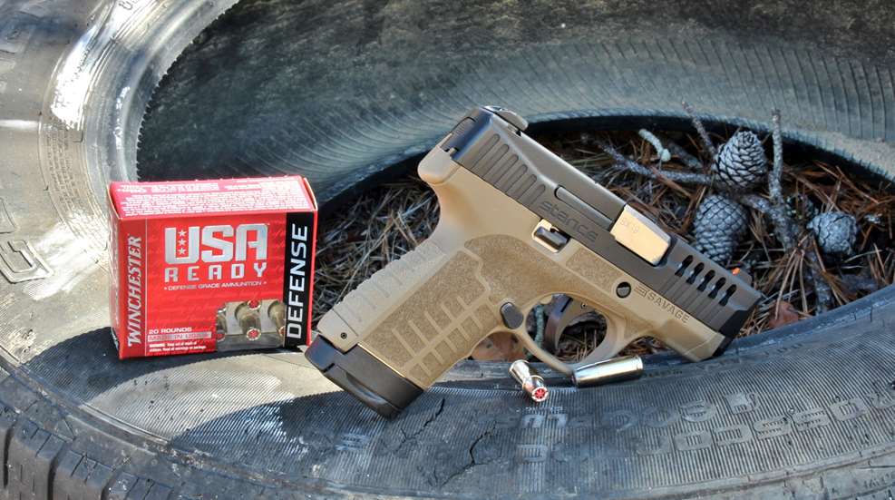 Savage Stance and Winchester USA Ready ammunition posed on tire