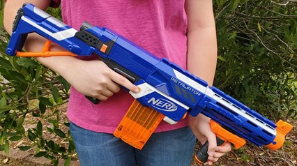 child holding nerf gun