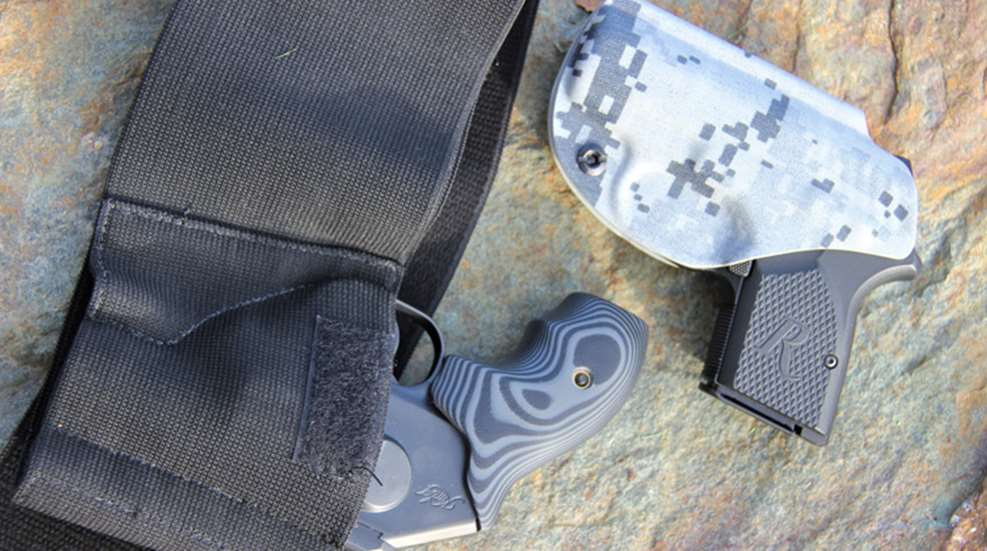 two deep-concealment holsters with firearms