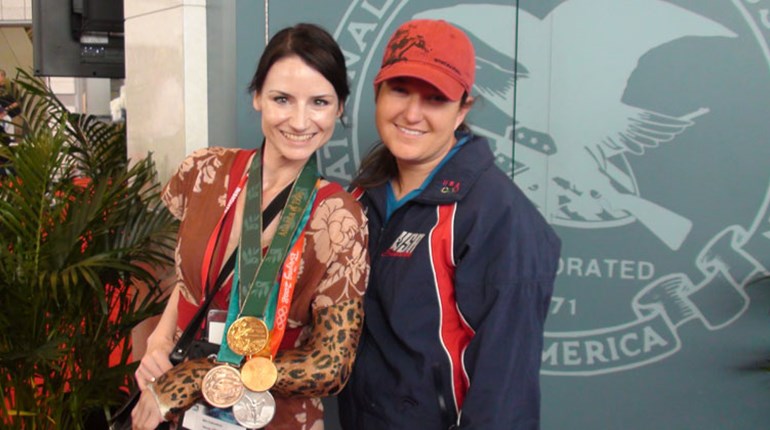 author in long-arm cast posing with Olympian Kim Rhode