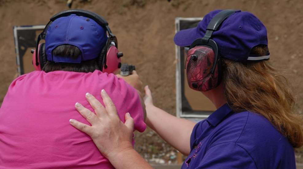 instructor helps student with proper Weaver stance